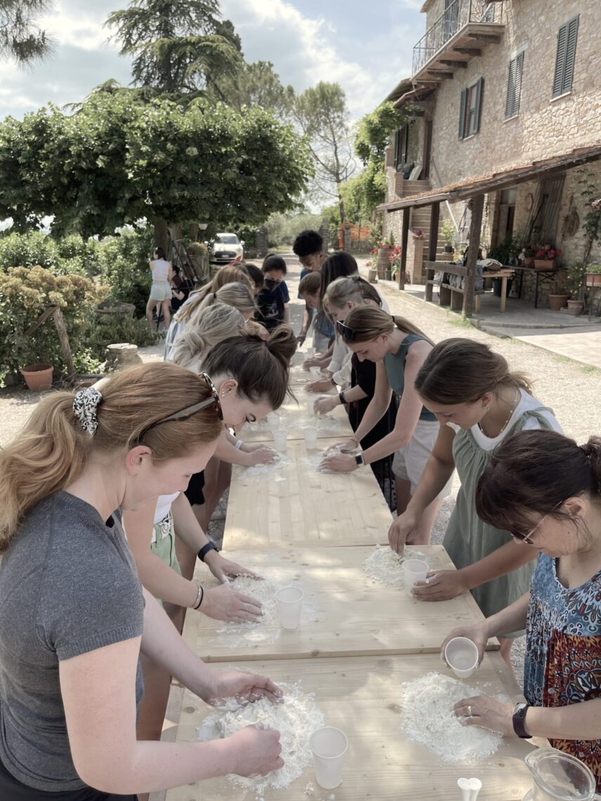 Participats of the study abroad programme during an outdoor cooking lesson in Umbria