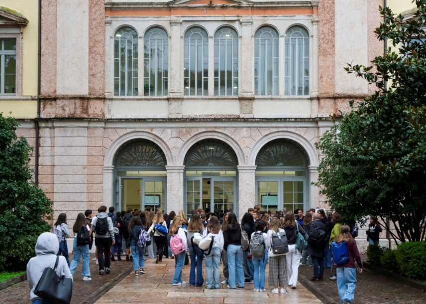 A large group of students entering an Italian high school