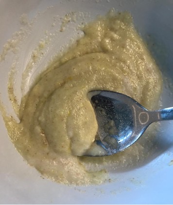 A photo of a spoon mixing Sprinkles porridge in a bowl