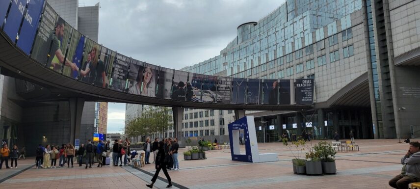 Posters of recent initiatives of the European Parliament, displayed across a footbridge spanning two buildings.