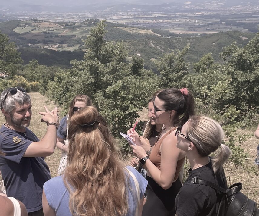 Group of students with Matteo Bartolini on a hill during a truffle walk