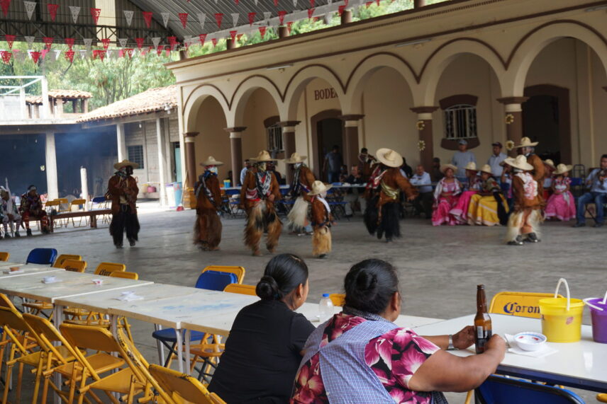 Photograph of two women sitting watching a perfomance