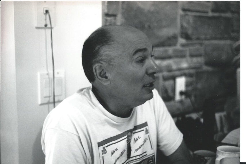 Black-and-white candid photo of anthropologist Renato Rosaldo speaking casually while wearing a t-shirt.