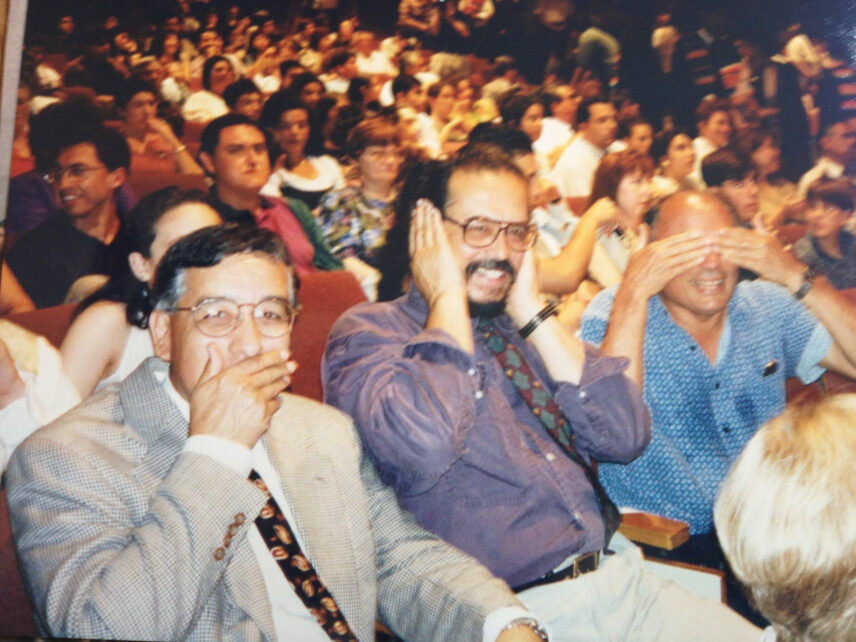 Renato Rosaldo and colleagues in the audience of a packed lecture hall playfully recreating "speak no evil, hear no evil, see no evil" gestures.